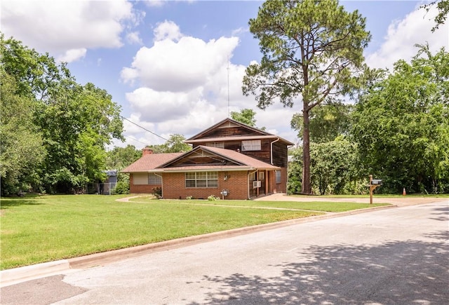 910 Briar Cliff Dr, Bryan, TX 77802 - view of front of house with a front yard, brick siding, and a chimney