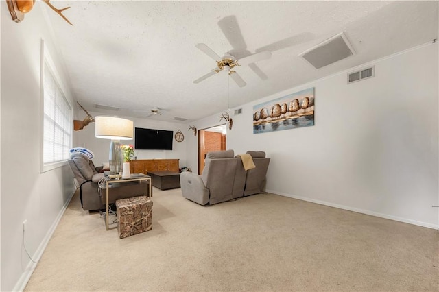 910 Briar Cliff Dr, Bryan, TX 77802 - carpeted living area featuring ceiling fan and a textured ceiling