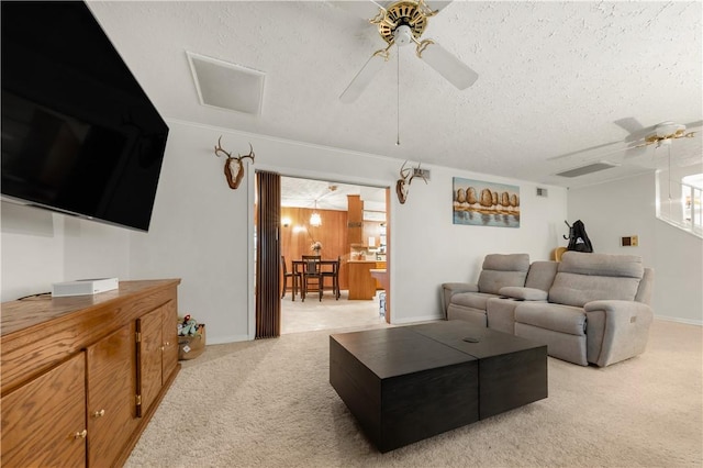 910 Briar Cliff Dr, Bryan, TX 77802 - living room featuring a ceiling fan, light carpet, and a textured ceiling