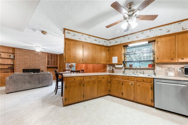 910 Briar Cliff Dr, Bryan, TX 77802 - kitchen featuring stainless steel appliances, ceiling fan, light countertops, and a textured ceiling