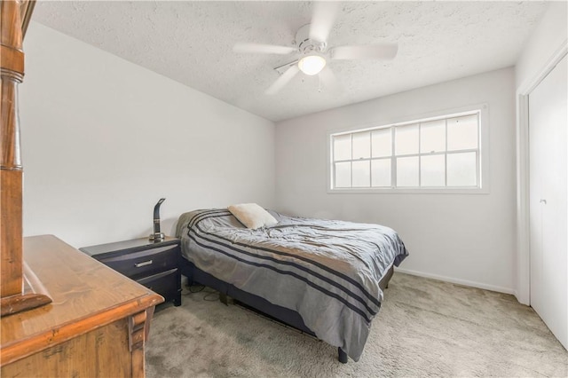 910 Briar Cliff Dr, Bryan, TX 77802 - carpeted bedroom featuring a textured ceiling and ceiling fan