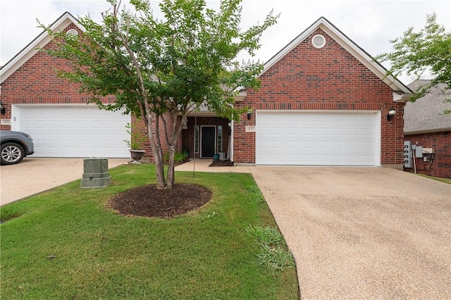 1607 Culture Ln, College Station, TX 77845 - view of front of home featuring a garage, concrete driveway, a front yard, and brick siding