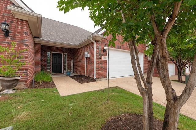 1607 Culture Ln, College Station, TX 77845 - view of exterior entry featuring a garage, a shingled roof, driveway, and brick siding