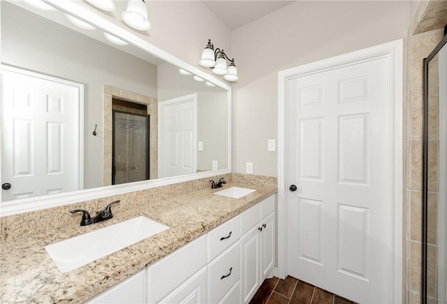 1607 Culture Ln, College Station, TX 77845 - full bath featuring double vanity, a tile shower, a sink, and wood finished floors