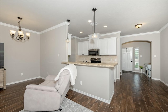 1607 Culture Ln, College Station, TX 77845 - kitchen featuring appliances with stainless steel finishes, baseboards, dark wood-style floors, and arched walkways