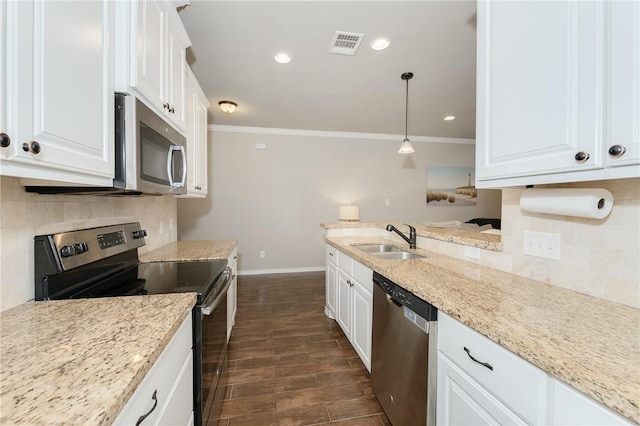 1607 Culture Ln, College Station, TX 77845 - kitchen featuring visible vents, crown molding, baseboards, a sink, and appliances with stainless steel finishes