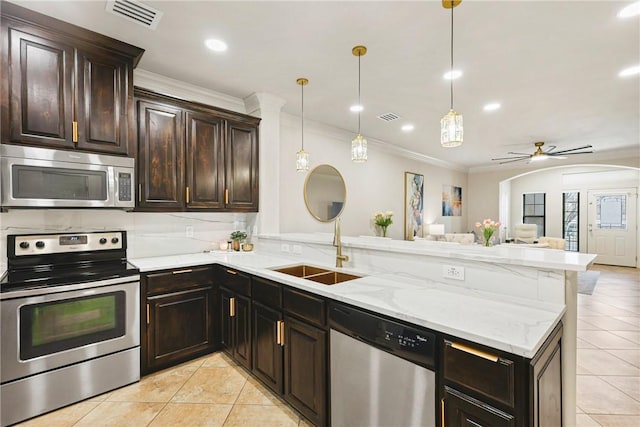 kitchen with visible vents, appliances with stainless steel finishes, open floor plan, a sink, and a peninsula