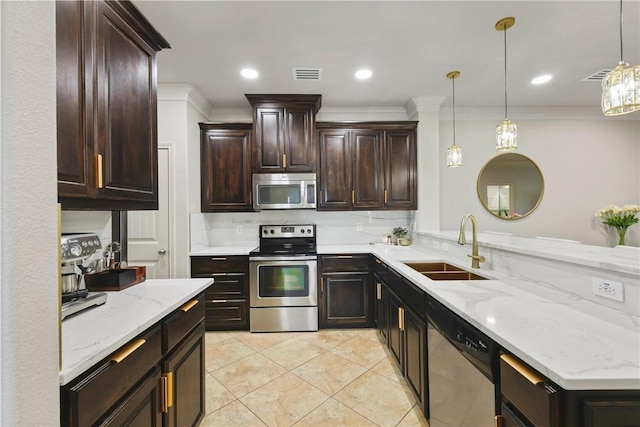 kitchen featuring visible vents, appliances with stainless steel finishes, pendant lighting, and a sink