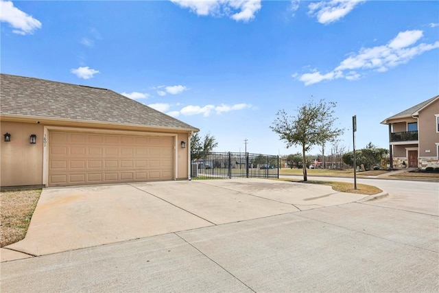 exterior space with concrete driveway and fence