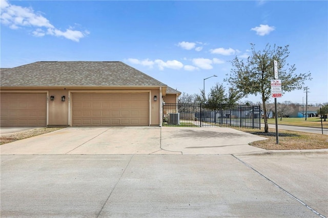 view of home's exterior featuring stucco siding, a shingled roof, concrete driveway, fence, and a garage