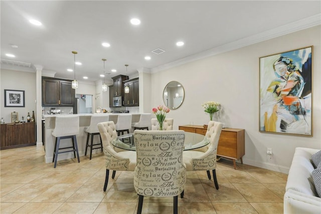 dining area featuring light tile patterned floors, ornamental molding, and recessed lighting