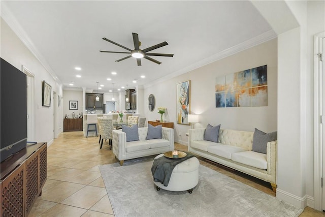 living area with light tile patterned floors, baseboards, a ceiling fan, crown molding, and recessed lighting