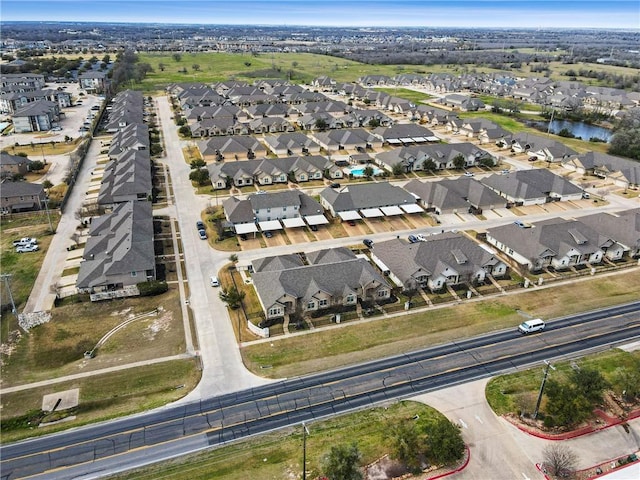 drone / aerial view featuring a water view and a residential view