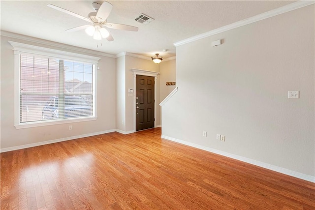 spare room with light hardwood / wood-style flooring, ceiling fan, and crown molding