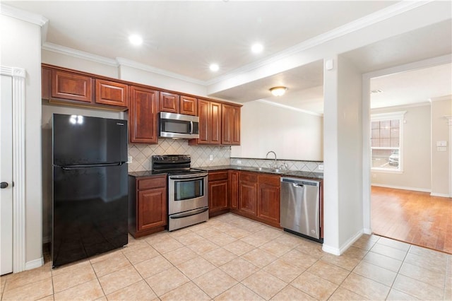 kitchen featuring crown molding, sink, light tile patterned floors, and appliances with stainless steel finishes