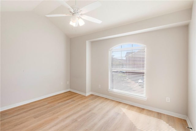 spare room featuring lofted ceiling, ceiling fan, and light wood-type flooring