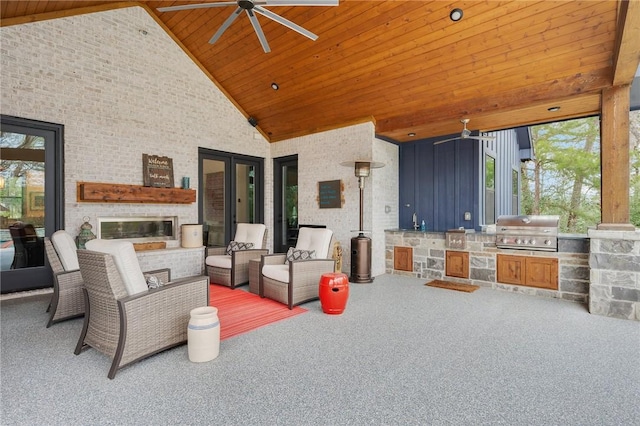 view of patio featuring area for grilling, sink, an outdoor brick fireplace, an outdoor kitchen, and ceiling fan