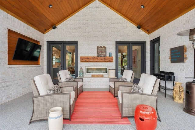 view of patio featuring french doors and an outdoor living space with a fireplace