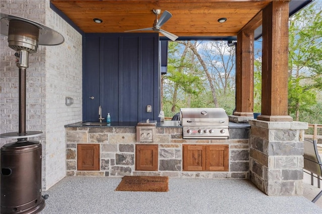 view of patio / terrace featuring ceiling fan, area for grilling, sink, and a grill