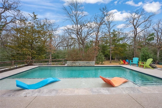 view of swimming pool featuring a hot tub and a patio area