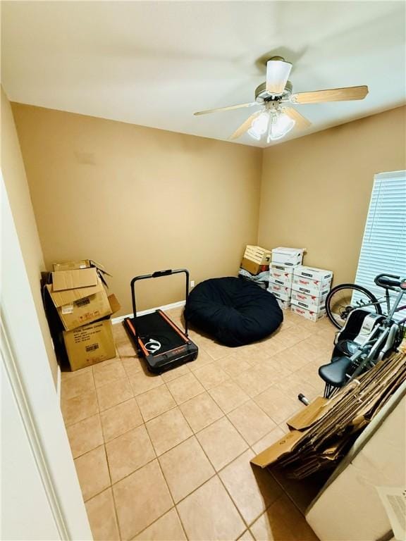 interior space featuring a ceiling fan and light tile patterned floors