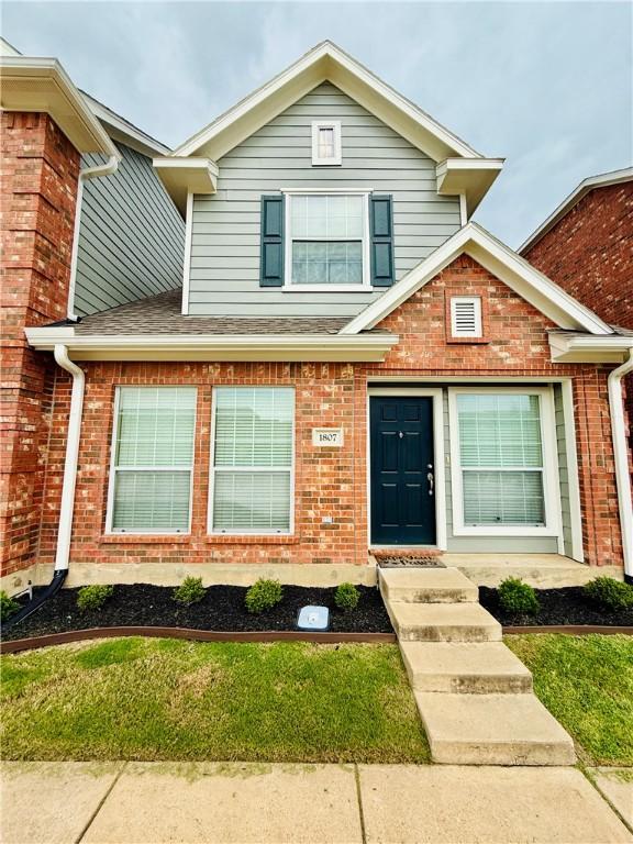 view of front of property featuring brick siding