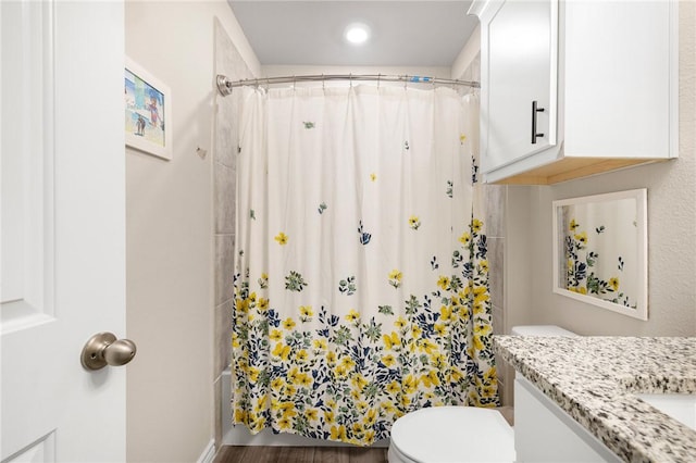 2110 Chief St, Bryan, TX 77807 - bathroom featuring curtained shower, toilet, vanity, and wood finished floors