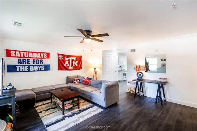 living room featuring ceiling fan, dark hardwood / wood-style flooring, and ornamental molding