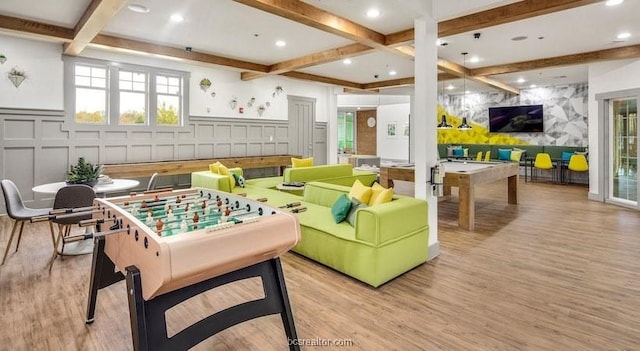 recreation room with beam ceiling, light wood-type flooring, and pool table