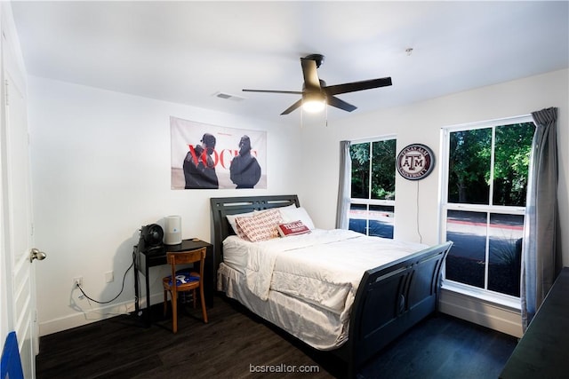 bedroom with ceiling fan and dark hardwood / wood-style floors