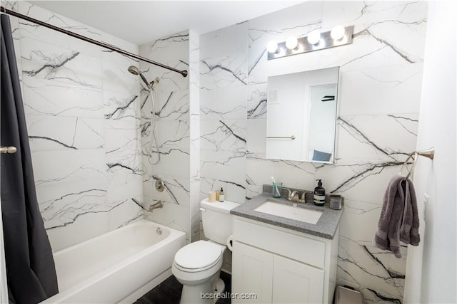 full bathroom featuring shower / tub combo, vanity, toilet, and tile walls