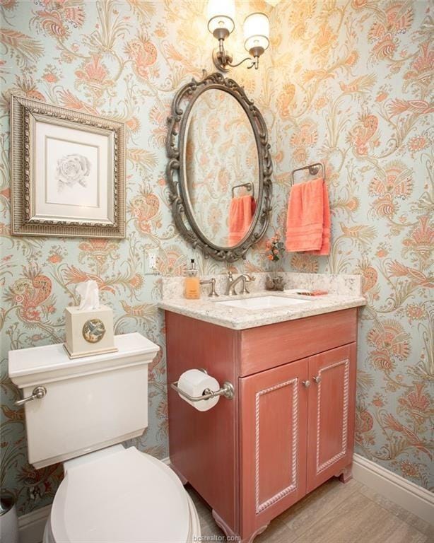 bathroom featuring vanity and toilet