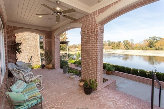 view of patio / terrace featuring ceiling fan and a water view