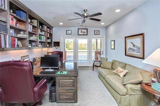 carpeted home office featuring ceiling fan