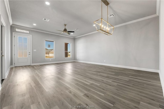 unfurnished living room featuring crown molding, ceiling fan with notable chandelier, and dark hardwood / wood-style floors