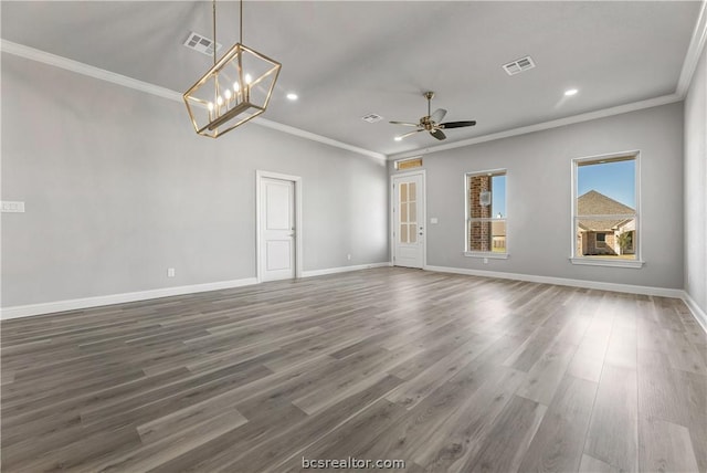 empty room with ceiling fan with notable chandelier, crown molding, and dark wood-type flooring