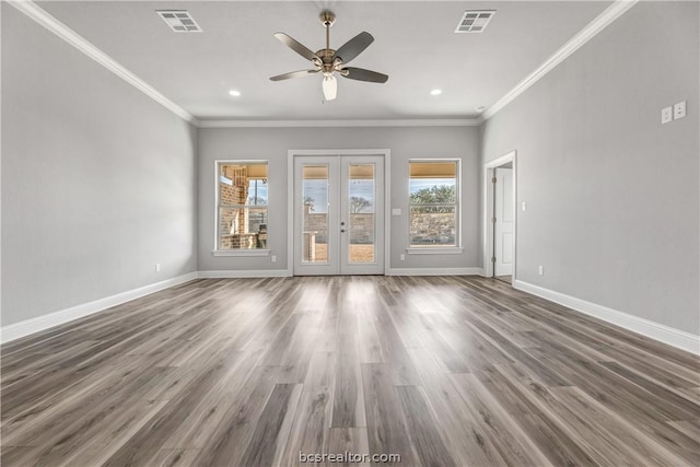 unfurnished room with french doors, dark hardwood / wood-style floors, crown molding, and a healthy amount of sunlight