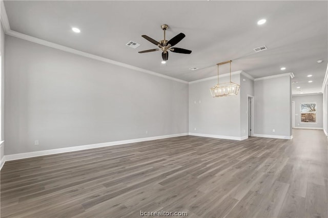 unfurnished living room featuring hardwood / wood-style floors, ceiling fan with notable chandelier, and ornamental molding