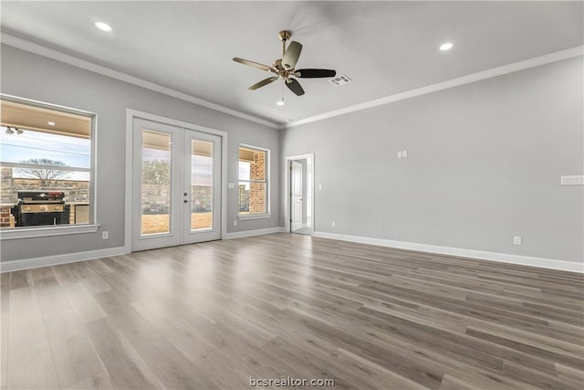 unfurnished room featuring ceiling fan, wood-type flooring, ornamental molding, and french doors