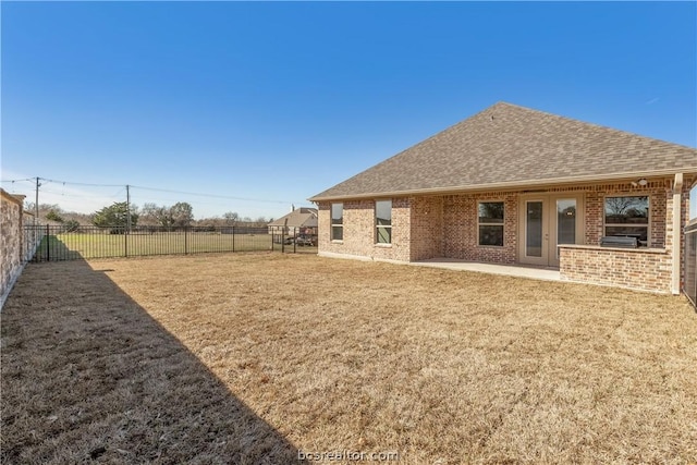 back of house featuring a yard and a patio