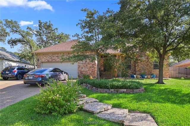 ranch-style home featuring a garage and a front lawn