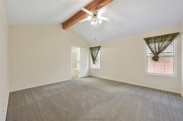 empty room with lofted ceiling with beams, carpet floors, a healthy amount of sunlight, and ceiling fan