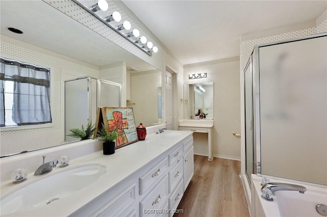 bathroom with shower with separate bathtub, vanity, and hardwood / wood-style flooring