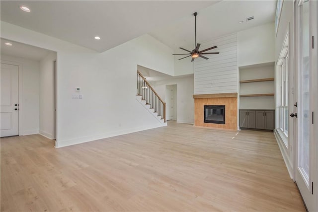 3034 Teller Dr, Bryan, TX 77808 - unfurnished living room featuring light wood-type flooring, stairway, baseboards, a ceiling fan, and recessed lighting