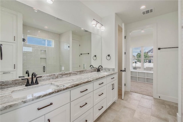 3034 Teller Dr, Bryan, TX 77808 - full bath with double vanity, a stall shower, and recessed lighting