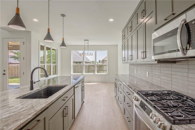 3034 Teller Dr, Bryan, TX 77808 - kitchen featuring stainless steel appliances, a sink, plenty of natural light, decorative backsplash, and recessed lighting