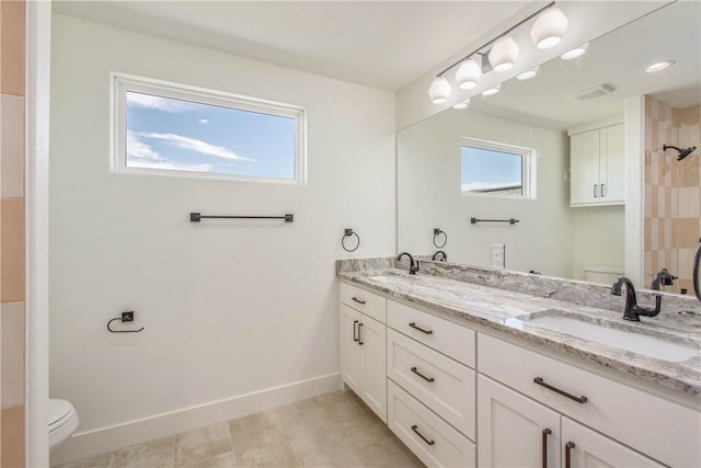 3034 Teller Dr, Bryan, TX 77808 - full bath with toilet, double vanity, a shower, and baseboards