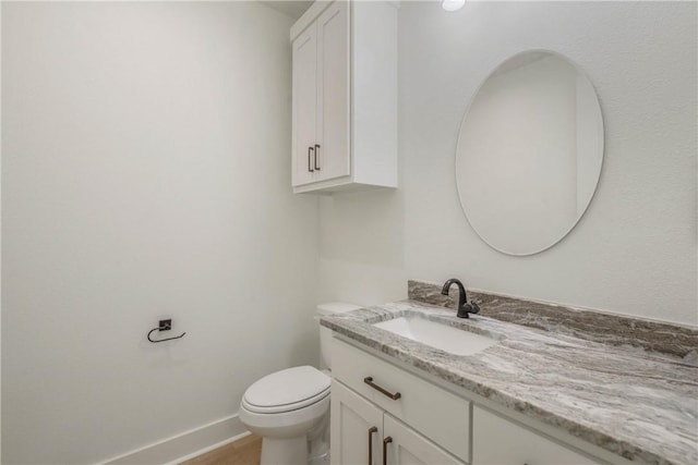 3034 Teller Dr, Bryan, TX 77808 - half bathroom with vanity, toilet, and baseboards