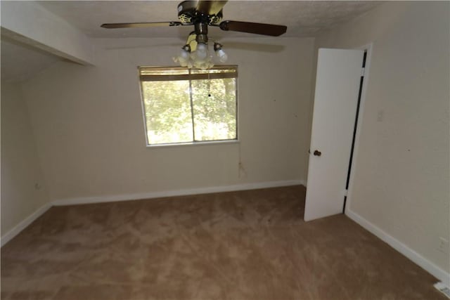 spare room with ceiling fan and carpet