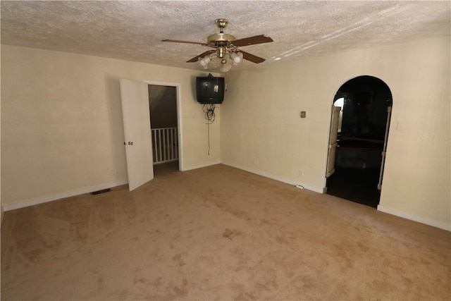 spare room with carpet floors and a textured ceiling